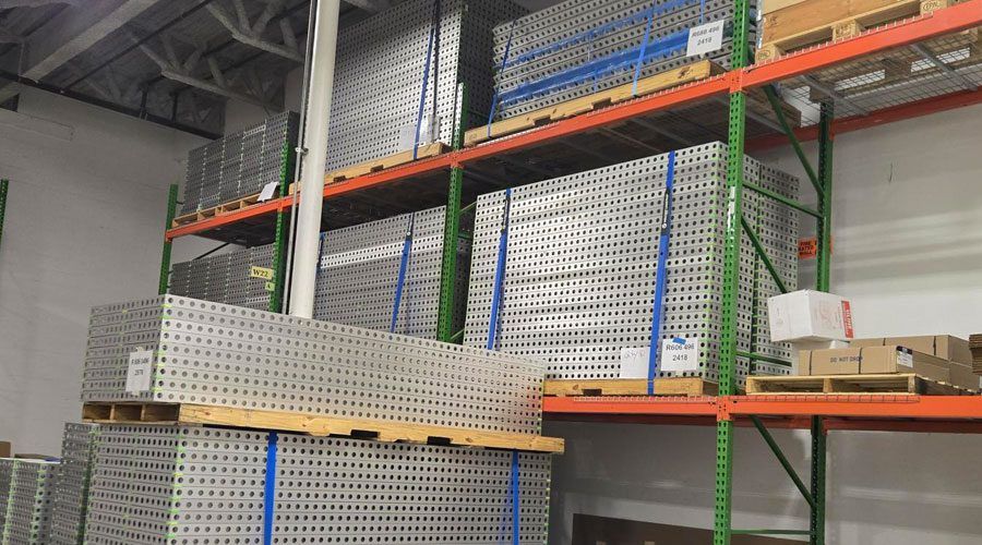 Aluminum frames secured in a warehouse with VELCRO® Brand LOGISTRAP® Pallet Strapping