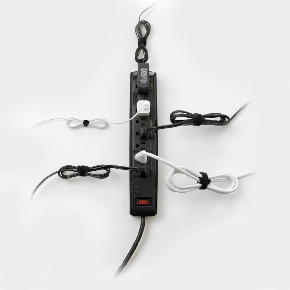 Outlet power strip with excess wires tidied using VELCRO® Brand ONE-WRAP® Cable Ties.