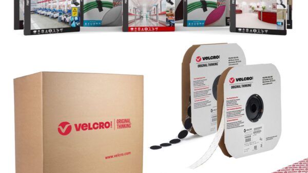 VELCRO® Brand fastening solutions including high-strength fasteners, ONE-WRAP® tape, general-purpose fasteners and ultra-thin fasteners shown in rolls and retail packaging with a VELCRO® Brand shipping box in the background.