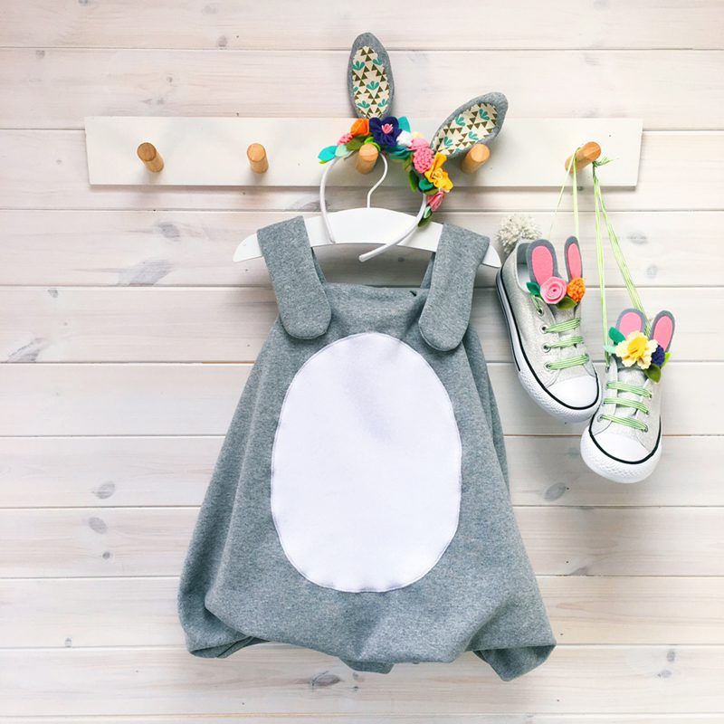 DIY Easter bunny costume for kids on hanger with bunny ears and sneakers.