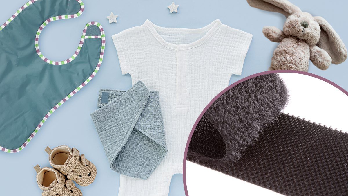 Infant apparel and accessories featuring VELCRO® Brand hook and loop fasteners, including baby shoes, bib, onesie and swaddle blanket.