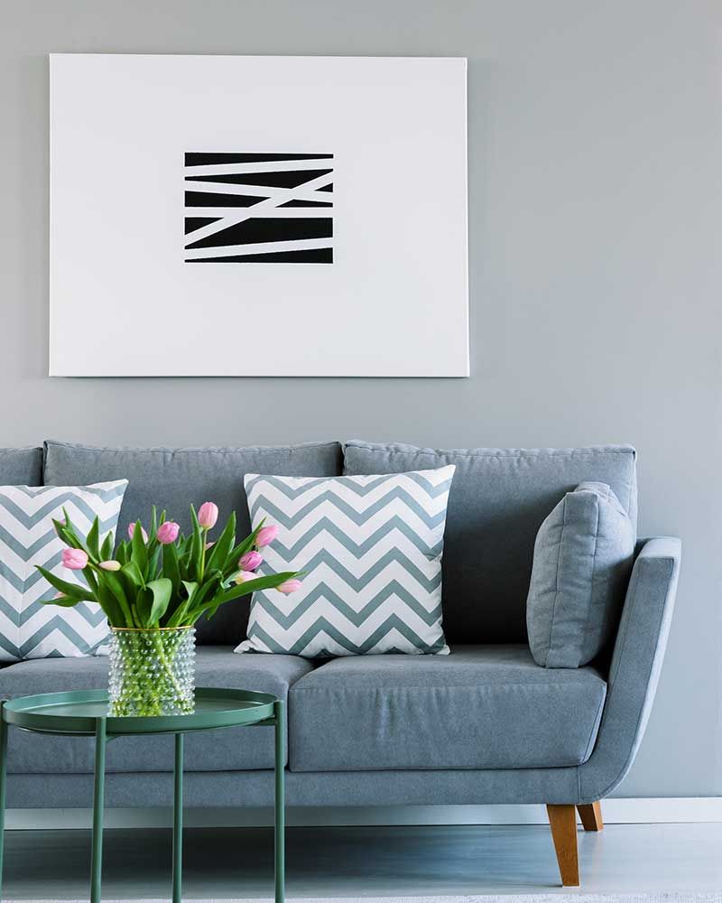 how high to hang pictures - above the sofa