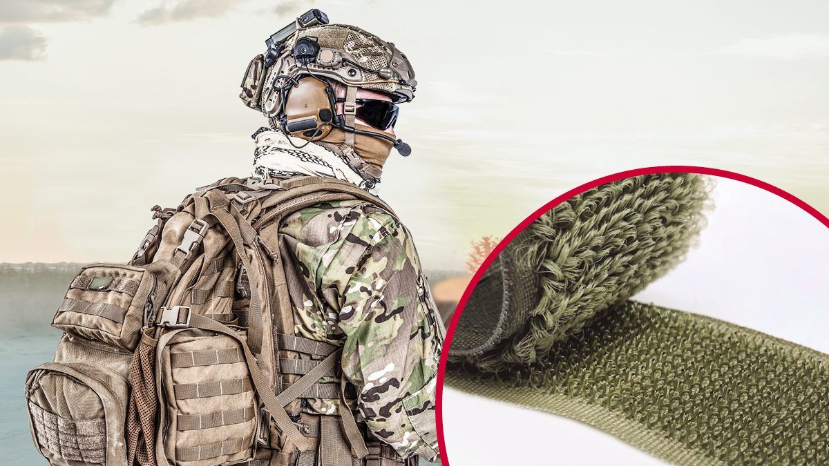 Soldier in camouflage gear with a helmet-mounted device and a tactical backpack secured with VELCRO® Brand hook and loop fasteners, featuring military fasteners, tactical gear, and VELCRO® Brand solutions for secure field equipment attachment.