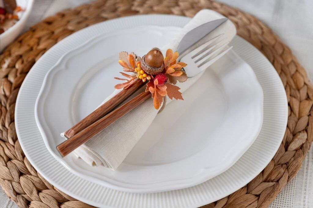 thanksgiving place setting white plates and a acorn napkin ring