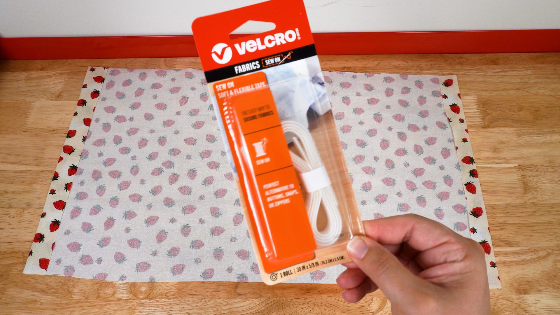 VELCRO® Brand Sew On Tape packaging being held up