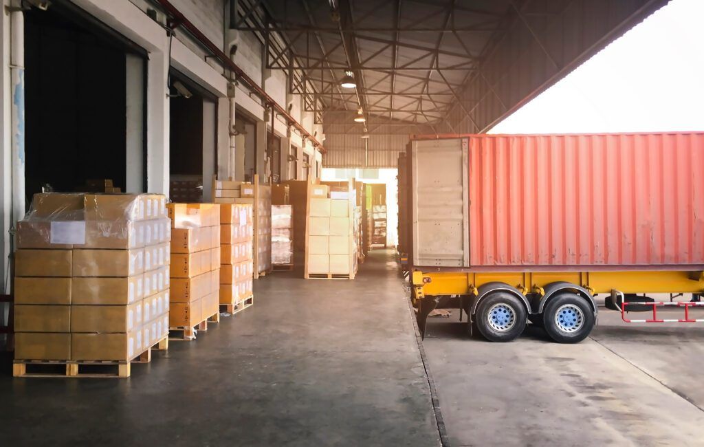 A shipping trailer waits at a shipping dock.