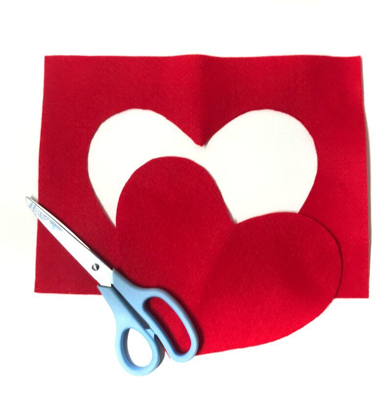 Red felt with heart cut from center for DIY Valentine's Day gift bag.