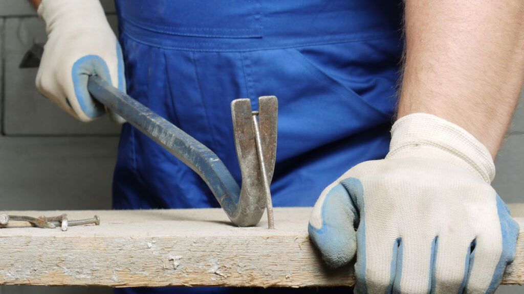 Removing nail from wood on a construction site