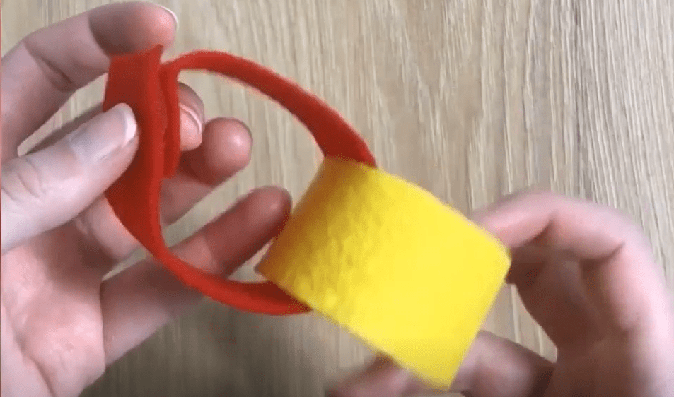 Hands creating links for a garland using VELCRO® Brand fabric tape.