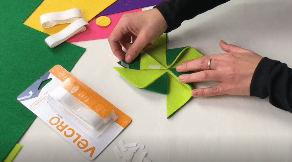 Hands creating a pinwheel using felt and VELCRO® Brand Sticky Back for Fabrics.